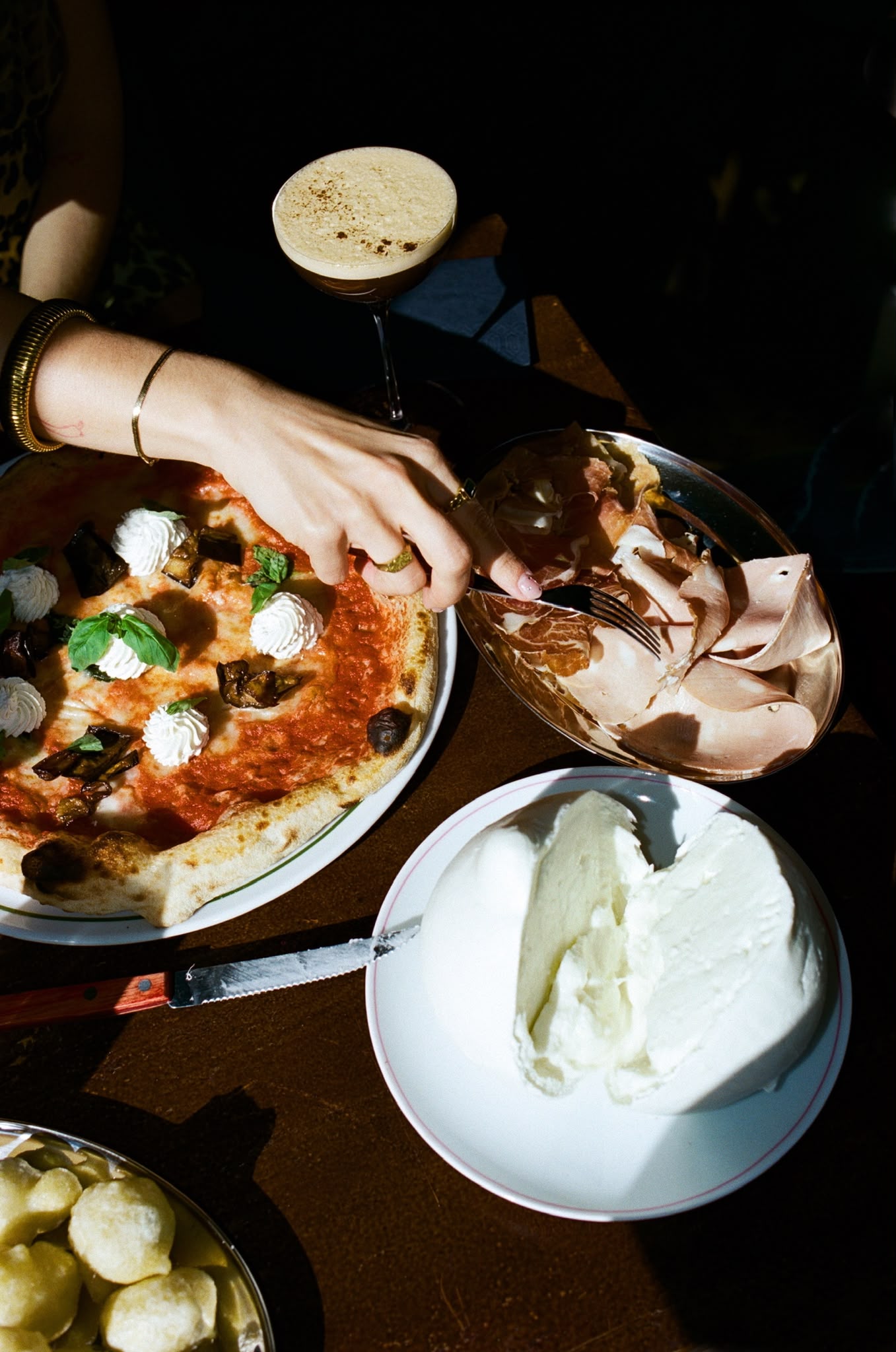 Pizza with an espresso martini and fresh burrata